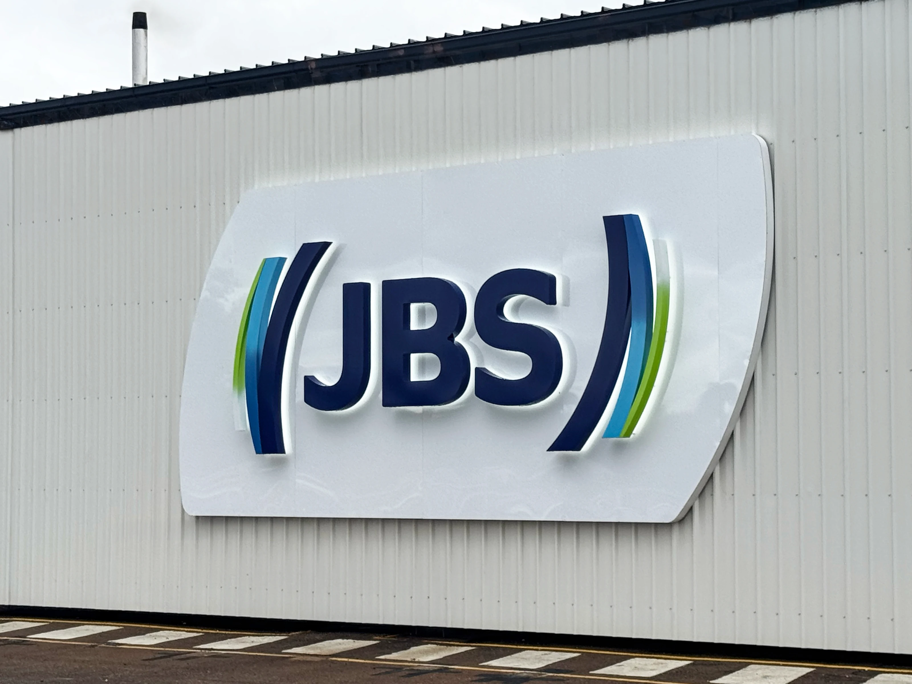 Illuminated JBS sign on the wall at JBS Townsville QLD