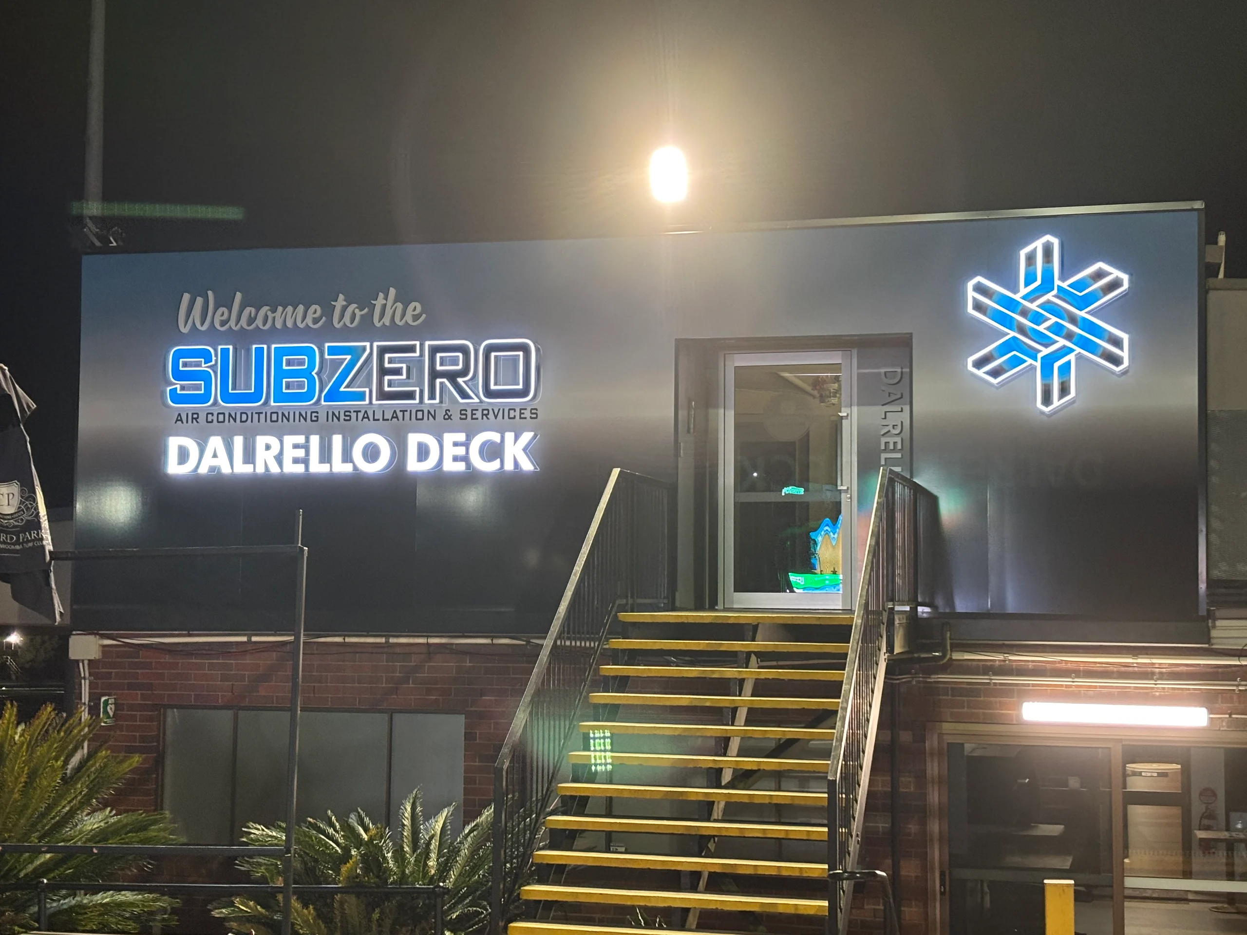 Subzero Dalrello Deck signage lit up at night, Toowoomba